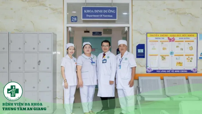 A group of people in white uniforms standing in front of a building Description automatically generated