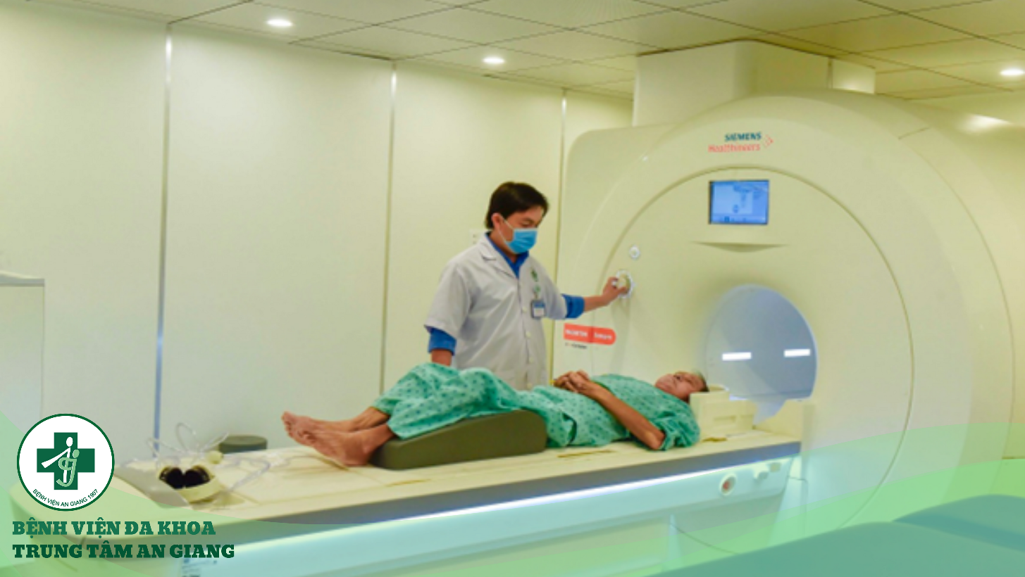 A person in a mask and a white coat with a patient lying on a ct scan machine Description automatically generated