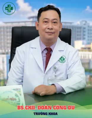 A person in a white coat sitting at a desk

Description automatically generated