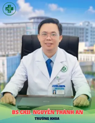 A person in a white coat sitting at a desk

Description automatically generated