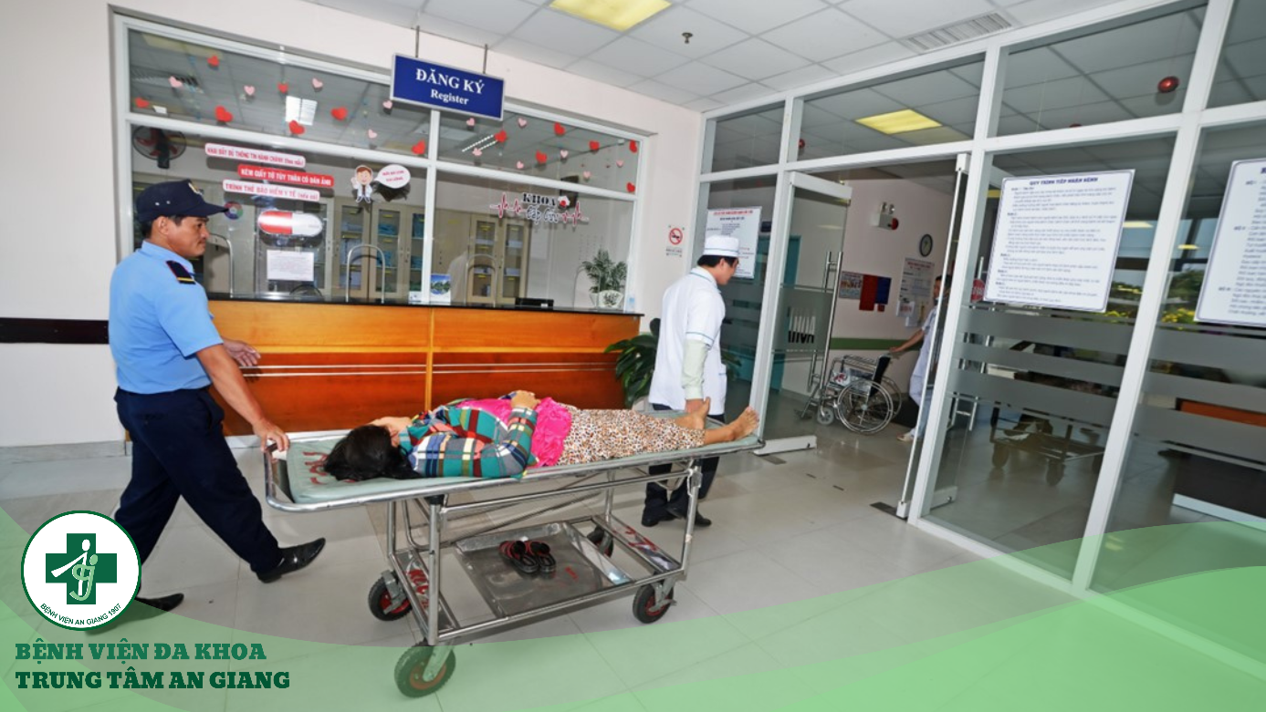 A person lying on a stretcher in a hospital
Description automatically generated